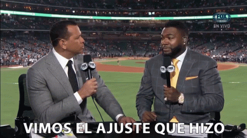 two men are talking in front of a fox sports stadium