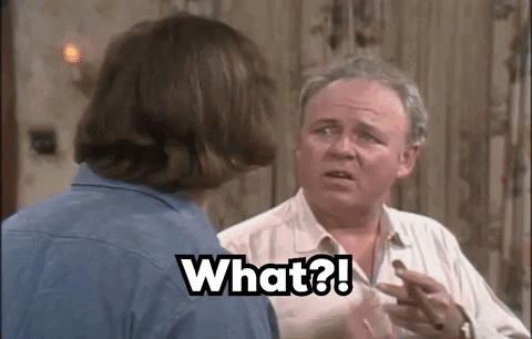Two Men Talking, One Holding Chocolate GIF