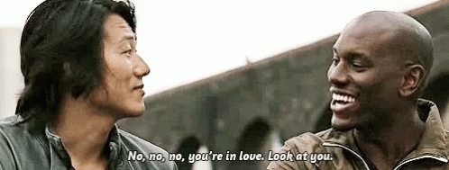 Two Men Are Talking To Each Other And One Of Them Is Laughing . GIF