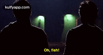 Two Men Are Talking To Each Other In A Dark Room And One Of Them Is Saying `` Oh , Fish '' . GIF