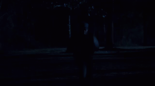 Two Men Are Walking In The Dark And One Has A Hoodie On GIF