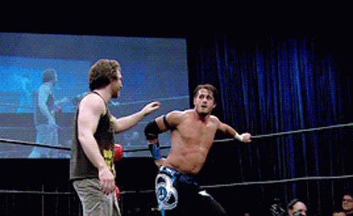 Two Men Are Wrestling In A Ring And One Has A Belt That Says ' A ' On It GIF