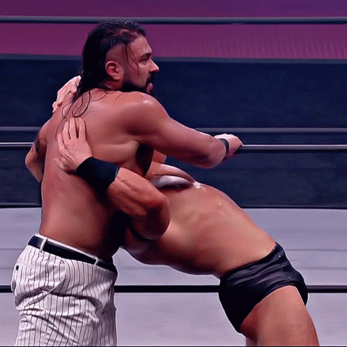 Two Men Are Wrestling In A Ring And One Is Wearing A Baseball Uniform GIF