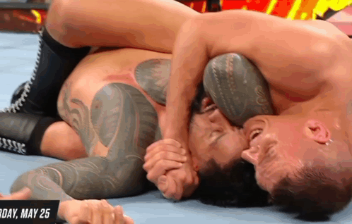 Two Men Are Wrestling In A Ring With The Date May 25 On The Bottom GIF