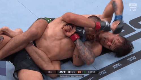 Two Men Are Wrestling In A Ufc Match With The Time Of 1:33 GIF