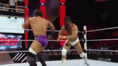 Two Men Are Wrestling In A Wrestling Ring And The Words W Live Are On The Screen GIF