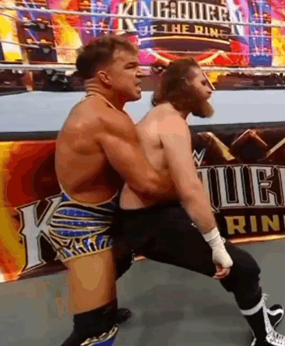 Two Men Are Wrestling In A Wrestling Ring With A Sign In The Background That Says King Of The Ring . GIF