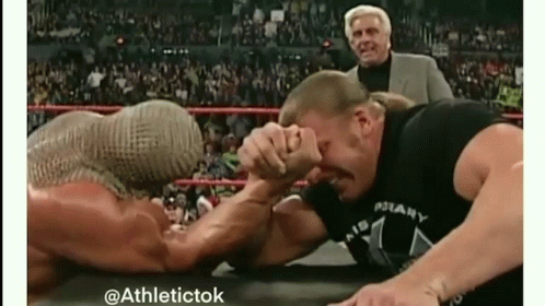 Two Men Arm Wrestling With Referee