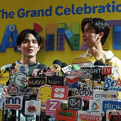 Two Men at Microphones and The Grand Celebratic Sign