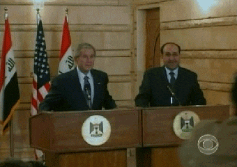 Two Men at Podiums with Flags