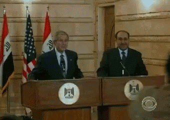 Two Men At Podiums With Flags And Circle F GIF