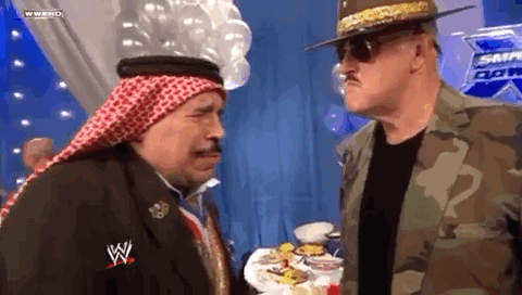 Two Men At Table With Food, One In Keffiyeh GIF