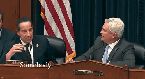 Two Men at Table with Name Plate Somebody