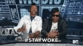 Two Men at Table With #Staywoke