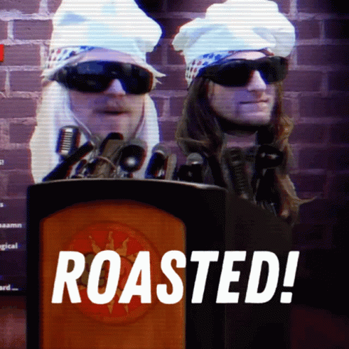 Two Men Behind A Podium With The Words Roasted On The Bottom GIF