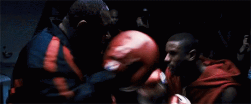 Two Men Boxing in Dark Room Red Gloves