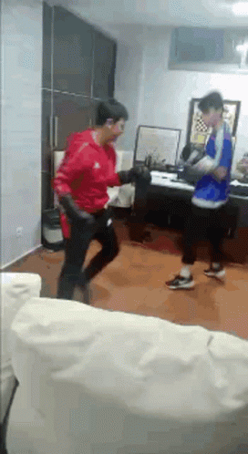 Two Men Boxing in Living Room