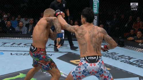 Two Men Boxing One With Venum Shorts