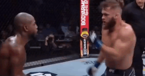 Two Men Boxing With Referee in Ring