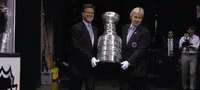 Two Men Bringing Stanley Cup To The Ice GIF