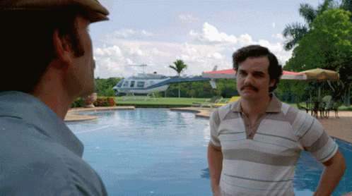 Two Men by Pool with Helicopter