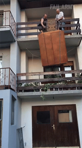 Two Men Carrying Large Furniture GIF