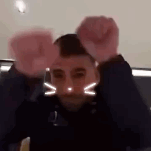 Two Men: Cat Face and Raised Fist