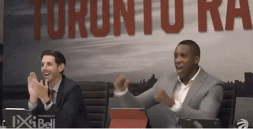 Two Men Clapping In Front Of Raptors Sign GIF