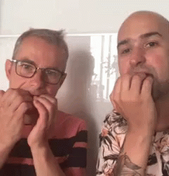 Two Men Covering Mouths One Wearing Glasses