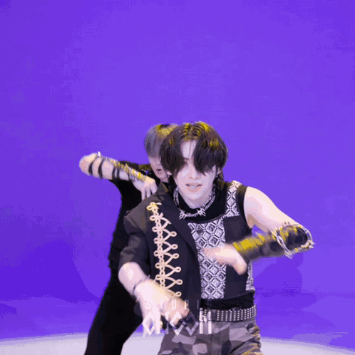 Two Men Dancing in Front of Studio Chaos