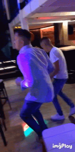 Two Men Dancing in Purple Light