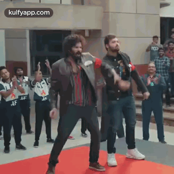 Two Men Dancing On Red Carpet In Front Of Crowd GIF