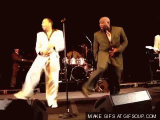Two Men Dancing On Stage GIF