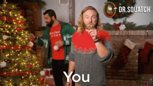 Two Men Decorating Christmas Tree One Wearing Merry Christmas Shirt GIF