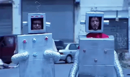 Two Men Dressed as Robots Walking Down Street
