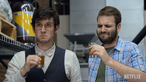 Two Men Drinking With Netflix Logo Behind GIF