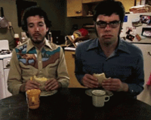 Two Men Eating One Wearing Cowboy Shirt GIF