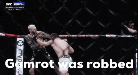 Two Men Fighting In A Cage With The Words Gamrot Was Robbed GIF