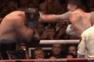 Two Men Fighting In Boxing Ring In Front Of Crowd GIF