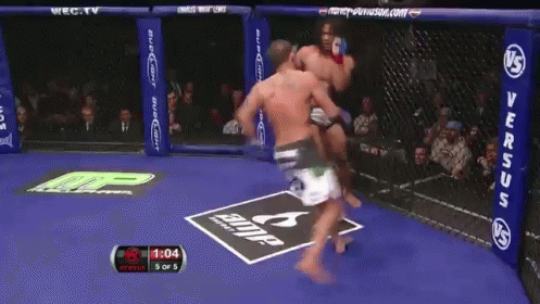 Two Men Fighting in Boxing Ring