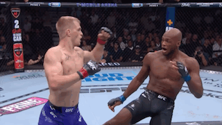 Two Men Fighting In Boxing Ring, One In UFC Shorts GIF