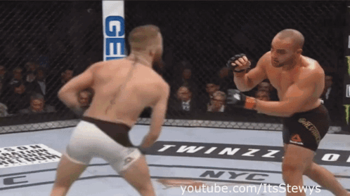 Two Men Fighting in Boxing Ring