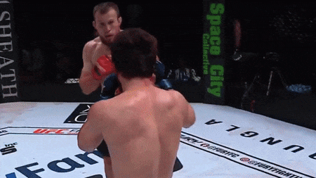 Two Men Fighting In Boxing Ring Space City Sign GIF