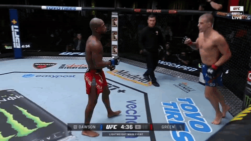 Two Men Fighting in Boxing Ring Sponsored by Toyo Tires and Energy Drinks
