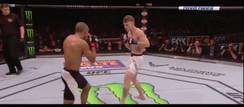 Two Men Fighting In Boxing Ring Sponsored By Toyo Tires And Monster GIF