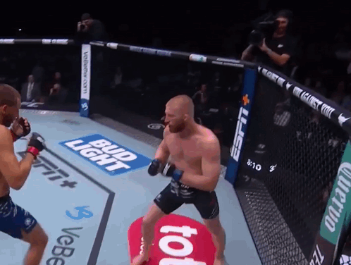 Two Men Fighting in Boxing Ring With Bud Light and ESPN