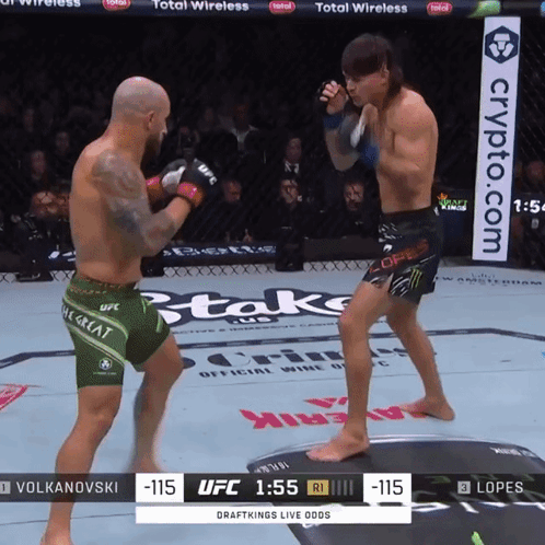 Two Men Fighting in Boxing Ring with Crypto.com Banner
