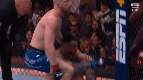 Two Men Fighting in Boxing Ring With Referee