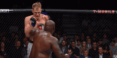 Two Men Fighting In Boxing Ring With T-Mobile Banner GIF
