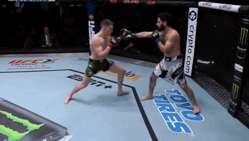 Two Men Fighting In Boxing Ring With Toyo Tires Banner GIF